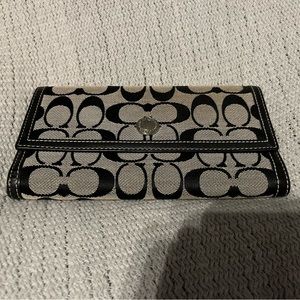 Large fabric Coach wallet with leather trim and leather inside.